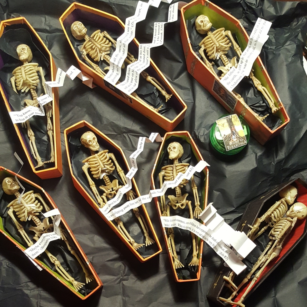 Halloween candy coffins holding plastic skeletons, a green container to look like an urn